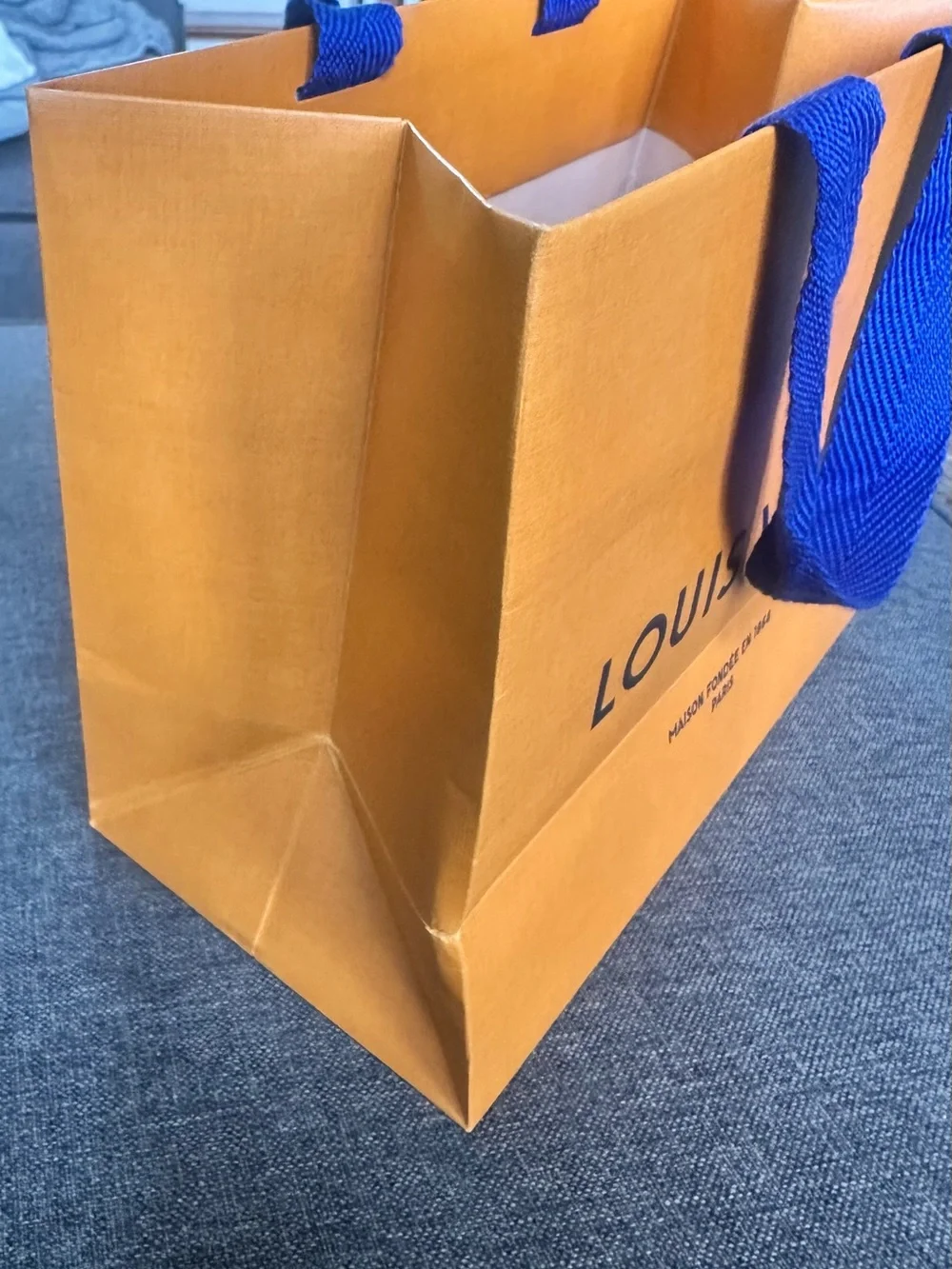 Louis Vuitton Orange Shopping Bag with Blue Handles and Black Logo
